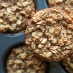 A banana oatmeal breakfast muffin on a muffin tin.