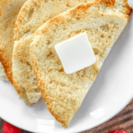 Slices of toasted bread on a white plate.