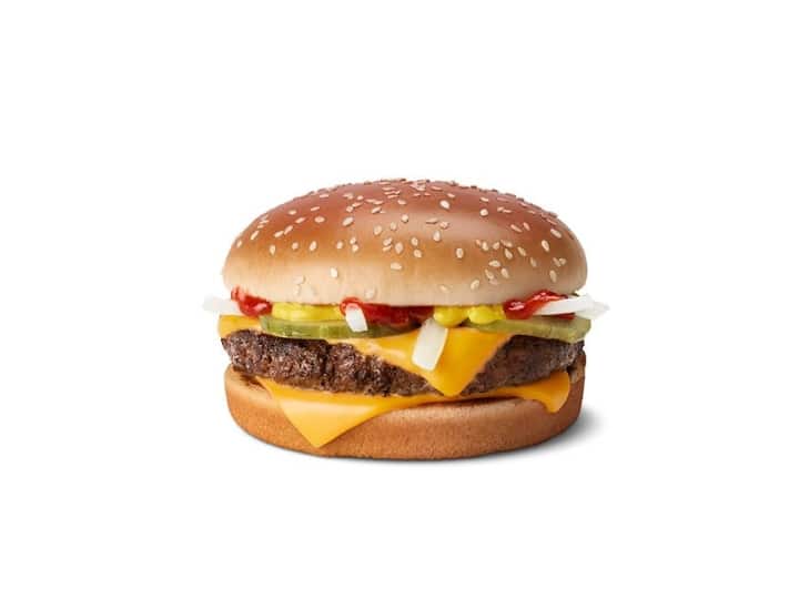 A cheeseburger with ketchup, pickles, and onion.
