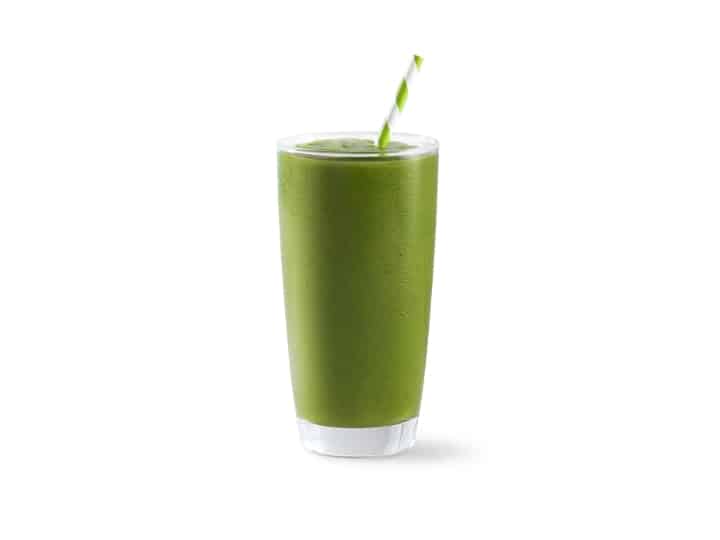 A green smoothie in a glass cup.