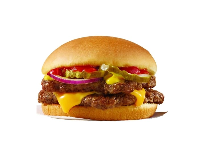 A double hamburger with cheese, ketchup, onion, and pickles.
