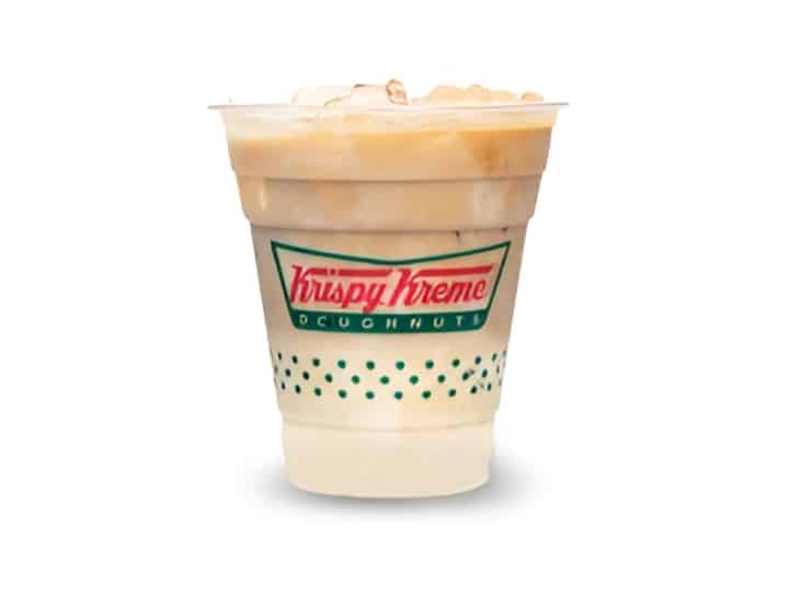 An image of an iced vanilla latte from Krispy Kreme in a plastic cup on a white background.