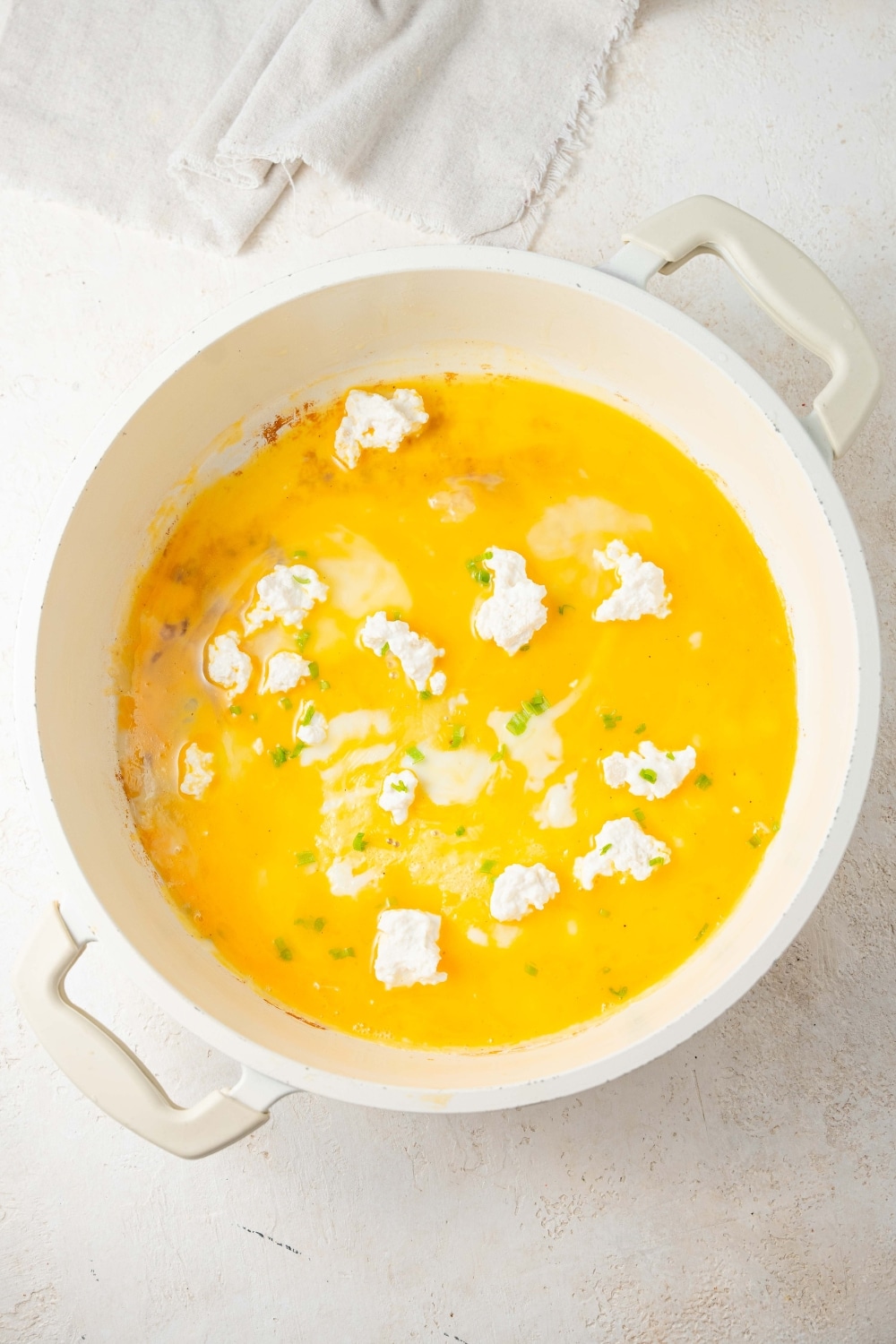 Eggs topped with cottage cheese in a pot.