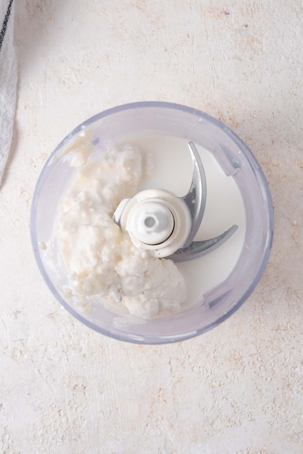 Cottage cheese and 2% milk in a food processor.