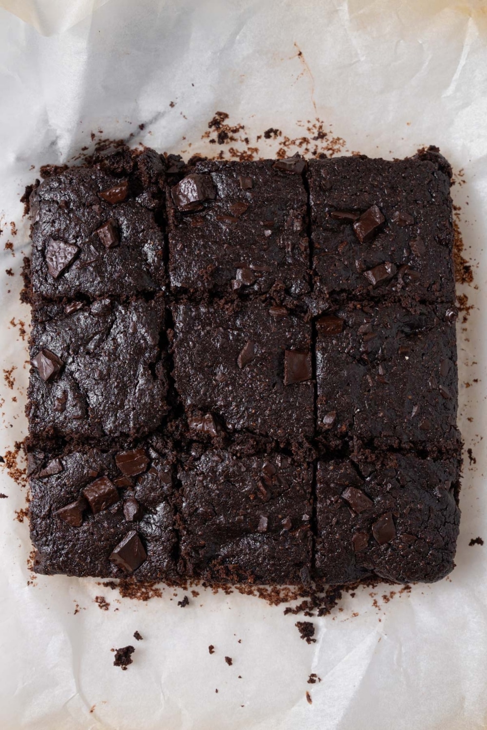 Freshly cut cottage cheese brownies on a parchment paper.