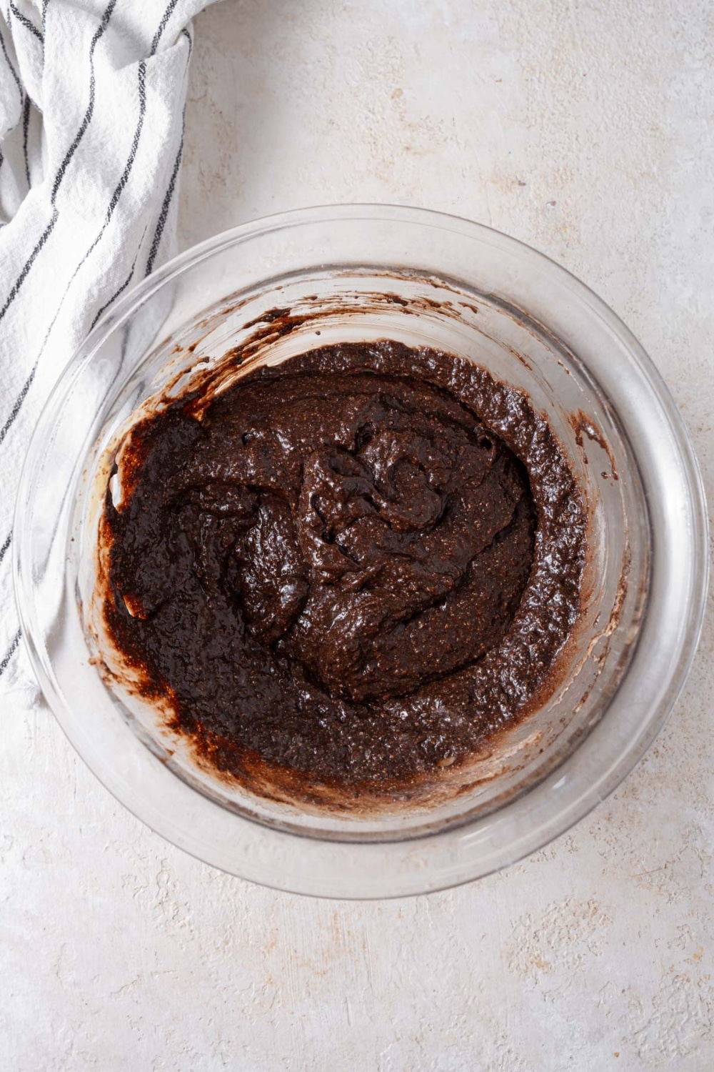 Cottage cheese brownie batter in a glass bowl.