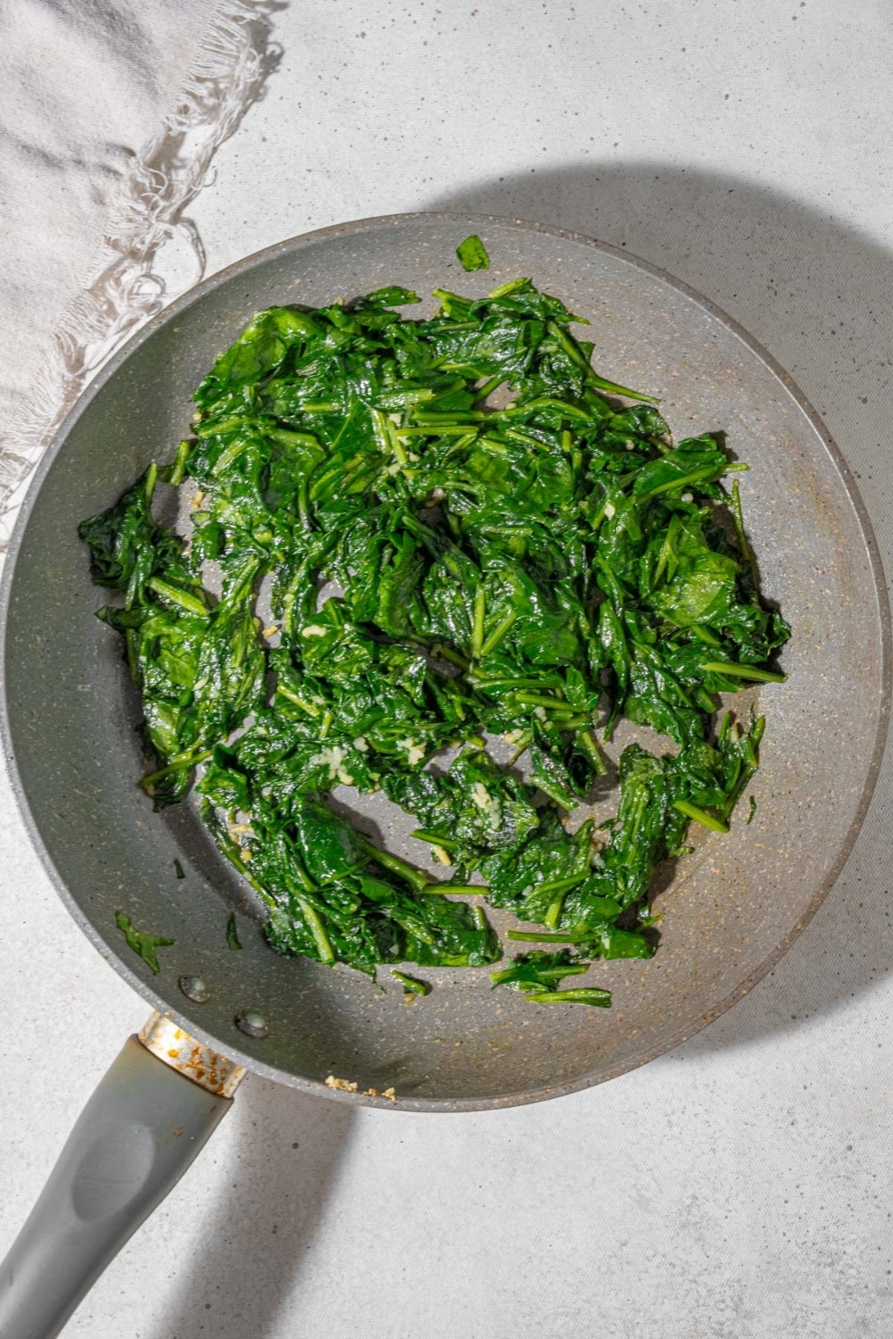 Sauteed spinach in a skillet.